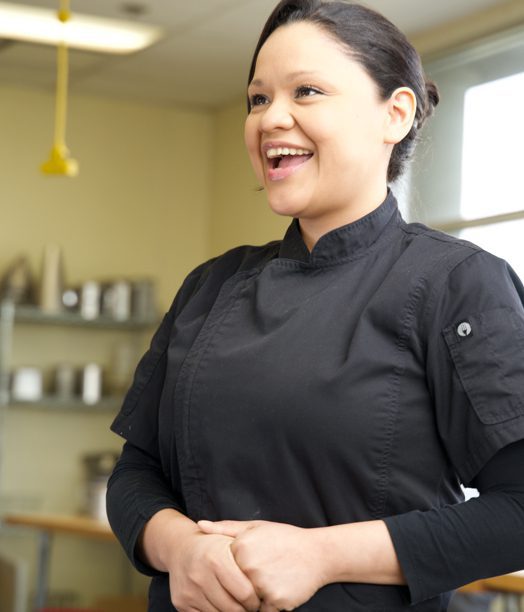 Smiling woman in chef's uniform