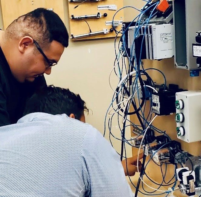 Two men practicing wiring
