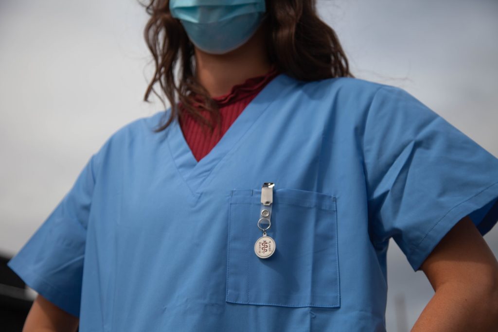 Person in scrubs and a mask