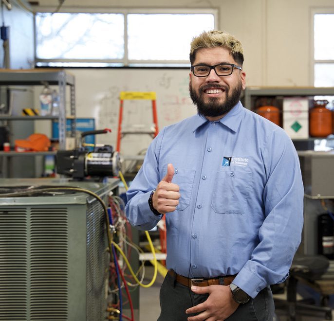 HVAC student smiling and giving a thumbs up