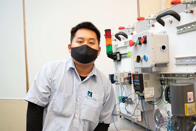 Student in front of electrical equipment