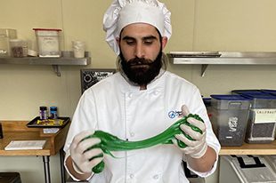 Man stretching green dough
